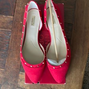 Red flats with gold stud detailing.